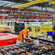 Workers put final touches to the battery pack atop an electric bus at BYD’s factory in Lancaster, California.